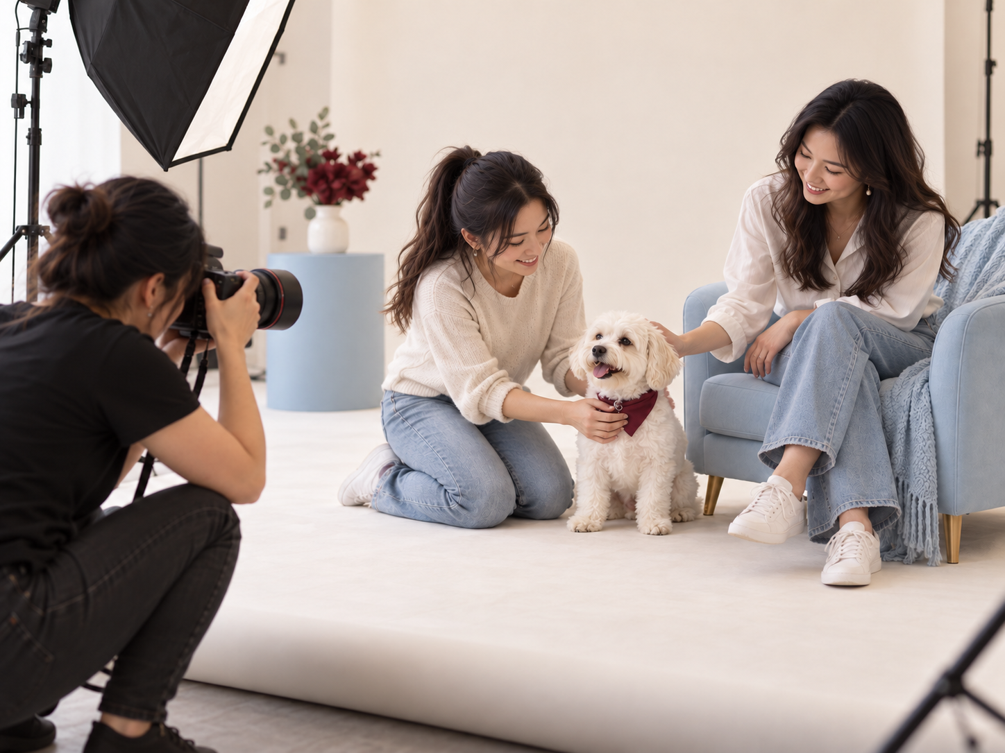 A photographer taking a studio portrait of two people and their white dog